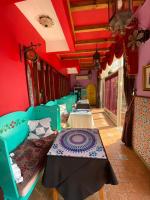 a room with several tables in a room with red walls at Raid Garden Boutique Hotel in Magong