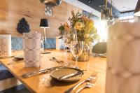 a wooden table with glasses and silverware on it at Das Metzgerbräu - Hotel & Brauereigasthof in Hohenwart