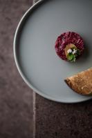 Un plato blanco con un trozo de comida encima. en fink Restaurant & Suites, en Brixen