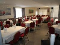 A restaurant or other place to eat at Hostal La Corte