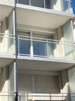 an apartment building with a balcony on the side of it at Mayfair in Le Touquet-Paris-Plage