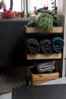 a shelf with towels on it next to a bed at La Cima del Valle in Valle de Guadalupe