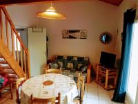 a dining room with a table and a couch at Maison Jard-sur-Mer, 3 pièces, 5 personnes - FR-1-485-78 in Jard-sur-Mer