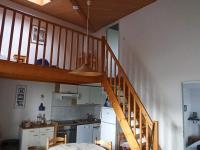 a kitchen with a wooden staircase in a house at Maison Jard-sur-Mer, 3 pièces, 5 personnes - FR-1-485-78 in Jard-sur-Mer