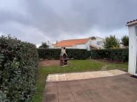 a yard with a statue in front of a house at Maison Jard-sur-Mer, 3 pièces, 5 personnes - FR-1-485-78 in Jard-sur-Mer