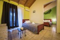 a bedroom with a bed and a table in a room at Pansion Porto Tsi Ostrias in Keri