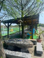 a picnic shelter with a table and a tree at Dongshan River Resort Farm in Wujie