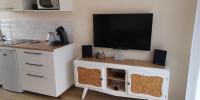 a living room with a tv on a wall at comme à la maison in Clonas-sur-Varèze