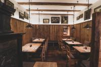 a restaurant with wooden walls and wooden tables and chairs at Boutiquehotel Weisses Rössl in Innsbruck