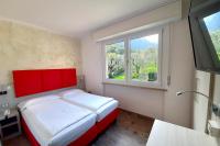 A bed or beds in a room at Hotel Da Tino