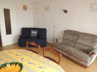 a living room with a couch and a table at Appartement Royan, 2 pièces, 4 personnes - FR-1-71-62 in Royan