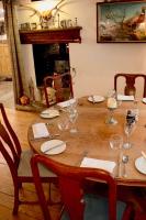 a wooden table with plates and wine glasses on it at The Lion, Tredington in Shipston on Stour