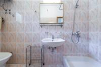 a bathroom with a sink and a toilet and a mirror at Apartmani Ivušić in Dubrava