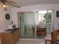 a kitchen with a sliding glass door with a table at Studio Sète, 1 pièce, 4 personnes - FR-1-338-406 in Sète