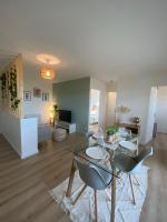Una sala de estar con una mesa de cristal y sillas. en Appartement cosy, vue imprenable, en Carcassonne