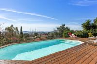 a swimming pool on top of a wooden deck at Maison du Baou - Welkeys in Toulon
