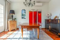 a dining room with a wooden table and chairs at Maison du Baou - Welkeys in Toulon