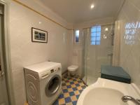a bathroom with a washing machine and a toilet at Maison Fouras, 6 pièces, 8 personnes - FR-1-709-39 in Fouras