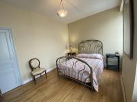 a bedroom with a bed and a chair at Maison Fouras, 6 pièces, 8 personnes - FR-1-709-39 in Fouras