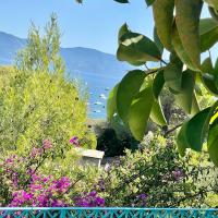 a view of the ocean from a garden with flowers at Villa Turquoise Sagone in Sagone