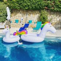 a pool with two inflatable unicorn floats in the water at Villa Turquoise Sagone in Sagone