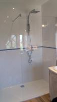 a glass shower in a bathroom with a sink at La Grange de Gournay in  Gournay-Loizé