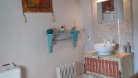a bathroom with a sink and a toilet at La Grange de Gournay in  Gournay-Loizé