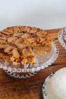 a pie on a glass plate on a wooden table at Pousada Villa Santô in Guarujá