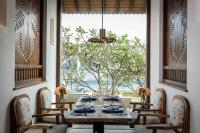 a dining room with a table and chairs and a window at Wattura Resort & Spa in Negombo