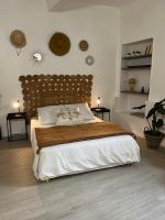 a bedroom with a large bed with a wooden headboard at L&#39;Auberge Espagnole - Bed &amp; Breakfast in Apt