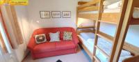 a room with a red chair and a bunk bed at Holiday home in Bad Mitterndorf - Steiermark 41114 in Bad Mitterndorf