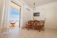 A television and/or entertainment centre at Kallopsia - Glifada Beach Menigos Resort by New Era