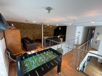 a view of a living room with a foos ball at Le Loft in Stoumont