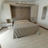 Łóżko lub łóżka w pokoju w obiekcie Hotel Arlecchino