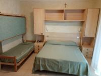 Łóżko lub łóżka w pokoju w obiekcie Hotel Arlecchino