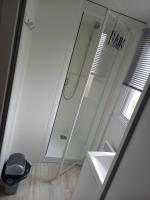 a bathroom with a shower and a sink and a mirror at Mobilhome 6 pers avec Clim in Saint-Georges-de-Didonne