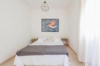 A bed or beds in a room at Kallopsia - Glifada Beach Menigos Resort by New Era