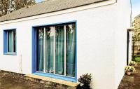 a house with blue windows on the side of it at Awesome Home In Paimpol With Kitchen in Paimpol