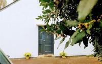 a green door on a white house with plants at Awesome Home In Paimpol With Kitchen in Paimpol