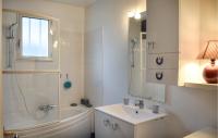 a bathroom with a tub and a sink and a shower at Awesome Home In Paimpol With Kitchen in Paimpol