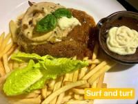 um prato de comida com batatas fritas e carne e molho em Playa Alegre Beach Resort & Restaurant em Tanauan