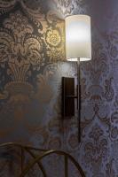 a lamp on a wall with a damask wallpaper at Alle Guglie Boutique Hotel in Venice