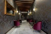 a waiting room with purple chairs and a mirror at Alle Guglie Boutique Hotel in Venice