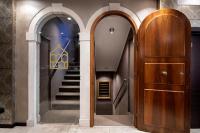 a hallway with two arches and a wooden door at Alle Guglie Boutique Hotel in Venice