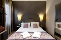 a bedroom with a large white bed with two pillows at Alle Guglie Boutique Hotel in Venice