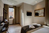 a hotel room with a bed and a desk and a mirror at Alle Guglie Boutique Hotel in Venice