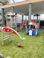 a playground with play equipment on the grass at Kapitańska 16C31 in Grzybowo