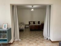 a bedroom with a bed and a window with curtains at T3 rénové esprit vintage, au coeur du Verdon in Montagnac