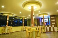 a restaurant with tables and stools in a room at Hotel Glory Garden in Pokhara