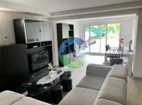 a living room with a couch and a tv at appartement au rez de jardin in Morangis